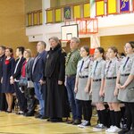 Stojący na baczność zaproszeni goście, księża, harcerze, rodzice podczas śpiewania hymnu